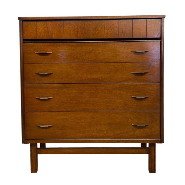 Mid century modern four-drawer dresser manufactured by Bassett Furniture Industries, Inc. This piece features a clean,...