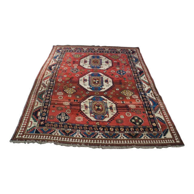 This striking antique "Lori Pambak" tribal rug is a commanding masterpiece of nomadic weaving. Featuring a vibrant madder-...