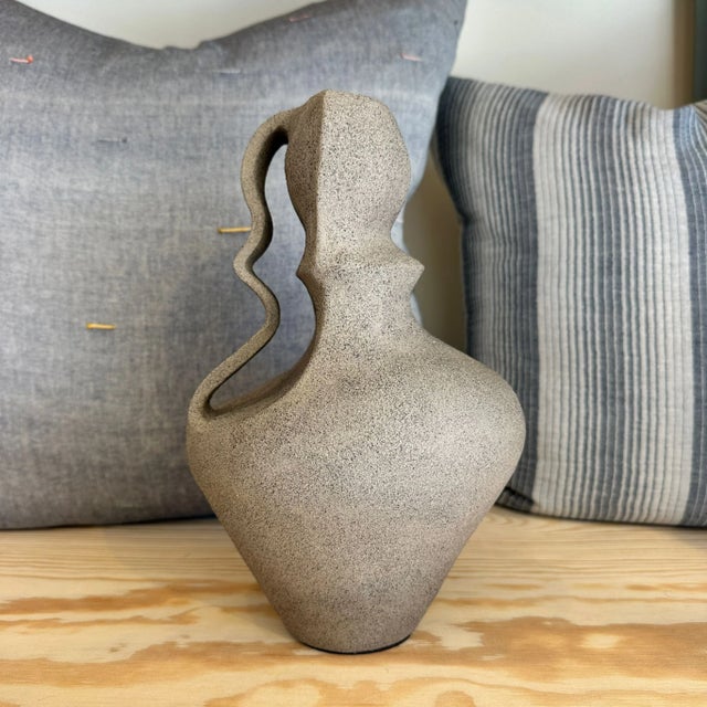 The handcrafted Erba ceramic vase blends modern design with timeless artistry. Its natural, unfinished texture gives it an...