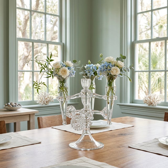 An elegant vintage clear pressed glass epergne centerpiece, featuring a sculptural three-arm form with removable trumpet...