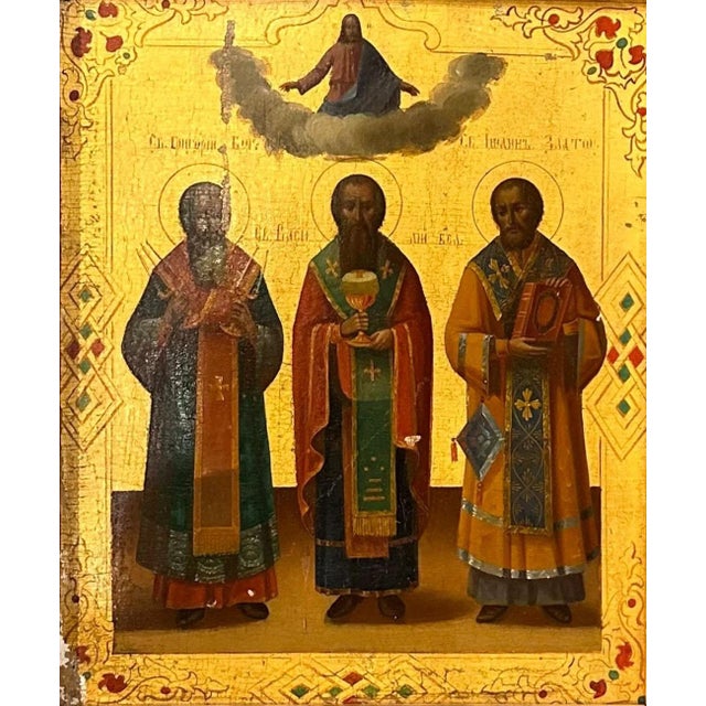 A striking early 19th century Russian icon, richly gilded depicting Jesus in the clouds above Saints Gregory, Vasili, and...