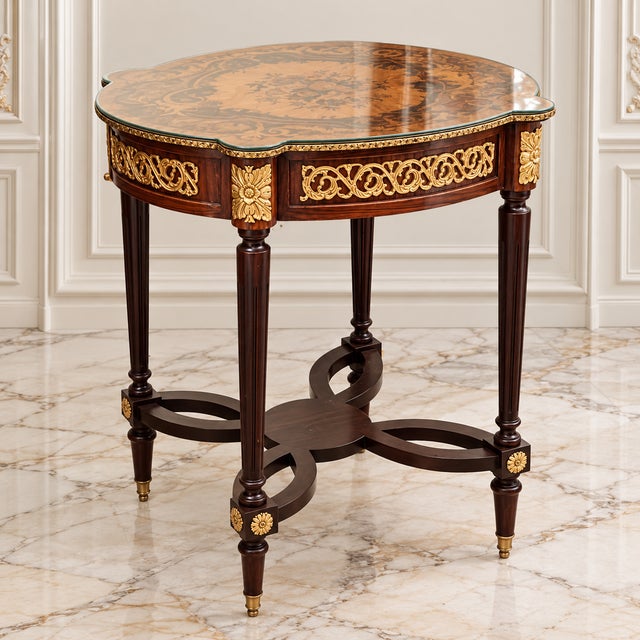 Elegant French style wood side table featuring a sophisticated glass top that beautifully showcases the decorative artwork...