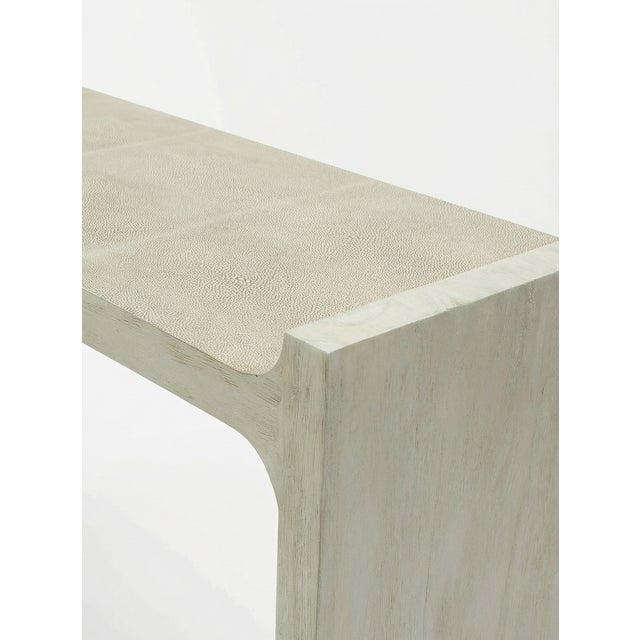 The Harper Console by Palecek features a refined mix of materials with a beige faux shagreen top and white-washed hardwood...