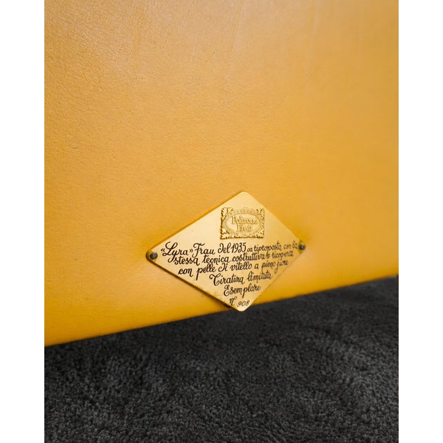 The Lyra armchair by Poltrona Frau is upholstered in a magnificent, warm Giallo yellow leather, displaying a beautiful...