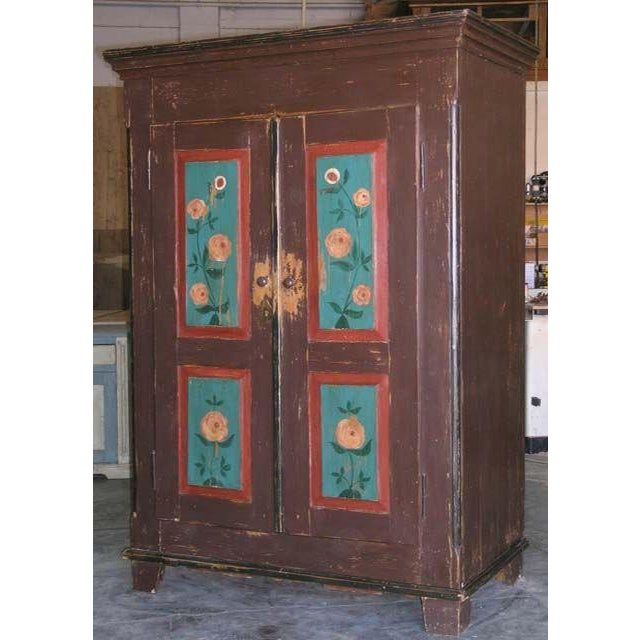 Folk art painted armoire. Interior shelving has been added to accommodate computer etc. We can customize interior for any...