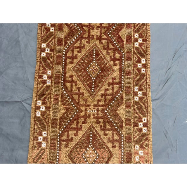 Welcome! This beautiful vintage Afghan Mishwani runner rug features a soft brown and beige color palette with geometric...