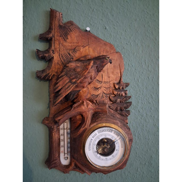 This black forest Thermometer & Barometer wall decoration with eagle, handcarved sculpture, is made in Germany. Black...