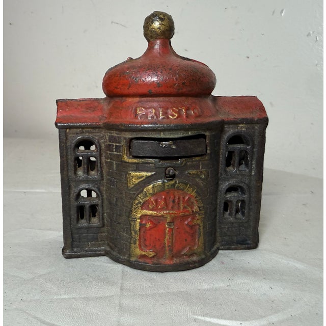 The Antique 1892 Kyser & Rex Cast Iron Mechanical Bank is a rare collectible piece that represents a piece of American...