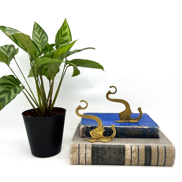 Fantastic brass wall hooks shaped like elephants, each with a raised, curling trunk that forms one hook and a second hook...