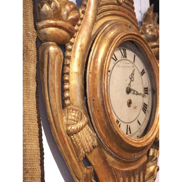 Dating to circa 1875, this giltwood barometer and cartel set were hand-carved in France in the style of Louis XVI. The...