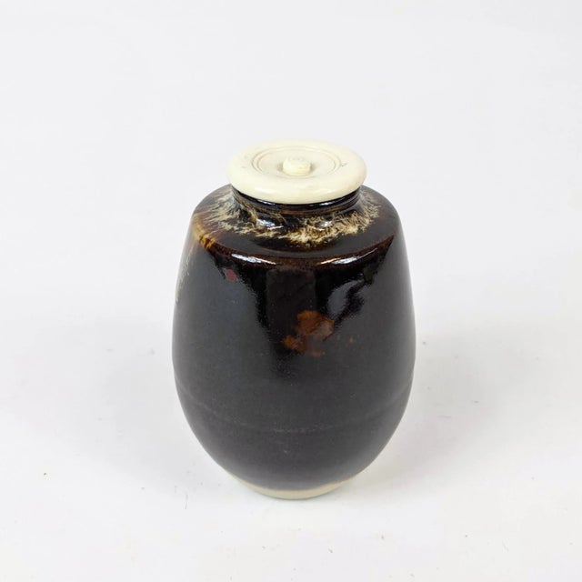 This is a small Japanese ceremonial container glazed in a brown and white glaze that almost looks like coffee with a milk!...