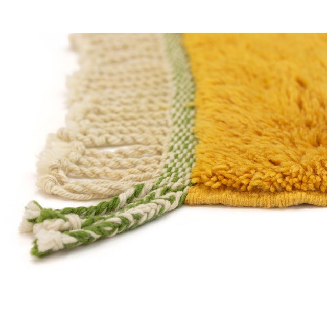 Vibrant hand-knotted wool rug with bold Marigold, Forest Green, and Dusk Rose sections on an Ivory background, presenting...