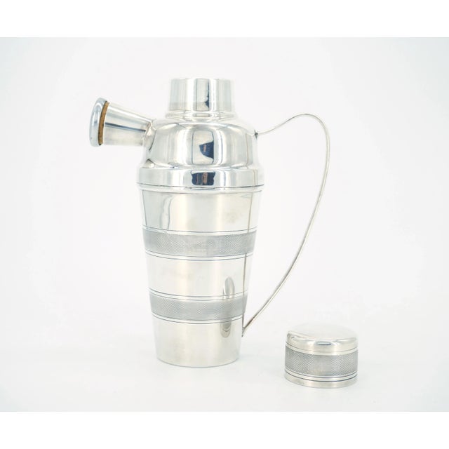 Edwardian period silverplate cocktail shaker with fine chased cross-hatch patterns on body and lid, and elegant handle.