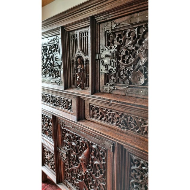 A 16th century flamboyant gothic carved oak cupboard circa 1500, possibly German or Flandres. The cupboard consists of two...