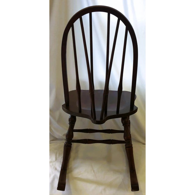 Beautiful, Windsor style, spindled wood rocking chair with wood dowel back. The wood is beautiful and the frame is sturdy....