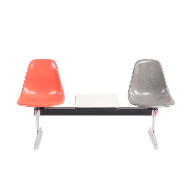 Eames Tandem Seating Group Design by Charles and Ray Eames Two fiberglass shell seats and a side table, crossbar with...