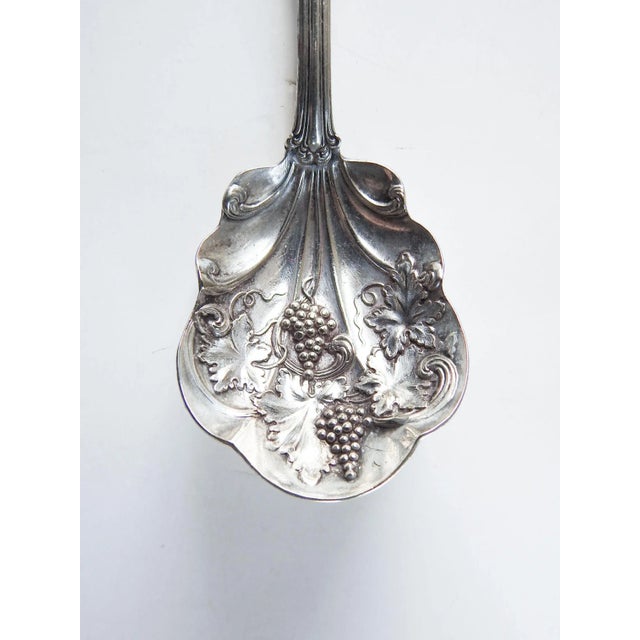 Circa 1910 American Silver Co. silverplate shell sugar spoon. Grape pattern, marked on back.