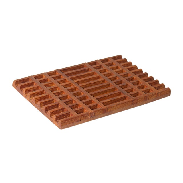 A trivet designed by the Danish designer Jens Quistgaard (1919-2008) for Dansk International Designs. Made of teak wood,...