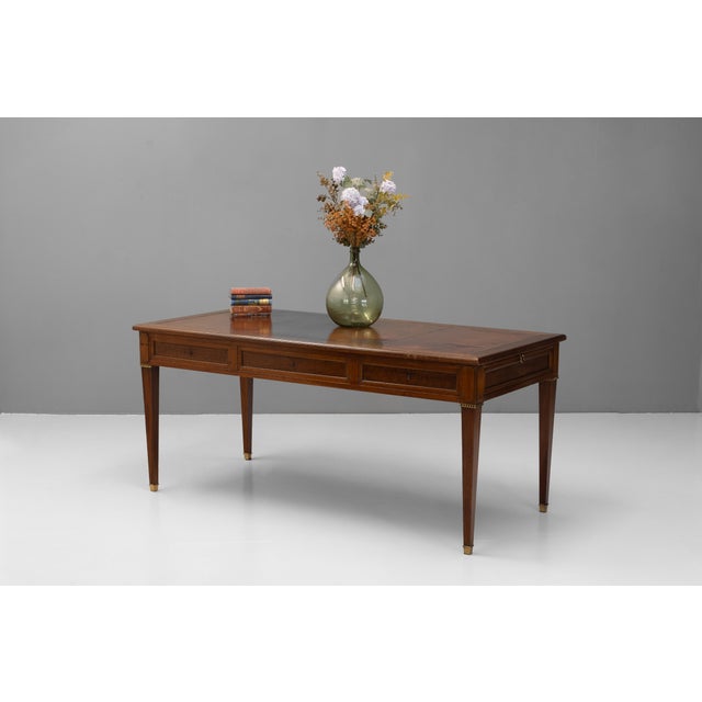 Large three drawer late 19th century mahogany writing table with original leather top. Two slides with original brass...