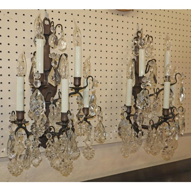 French Louis XVI Style Bronze and Crystal 5 Light Sconces Circa 1950's Dimensions :20" Tall X 14" Wide X 8" Deep This pair...