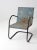 This is a mid-century metal bouncer chair. The classic patio chair has a blue bouncer frame and window slit detailed seat....
