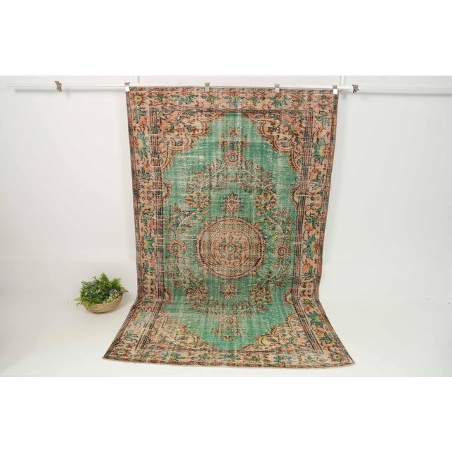 This vintage hand-knotted area rug is a semi-antique vintage area rug. The '70s Eastern Anatolian region's unique rug is...