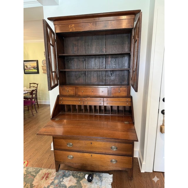 A stunning example of early American Federal craftsmanship, this two-part secretary bookcase is a true statement piece...