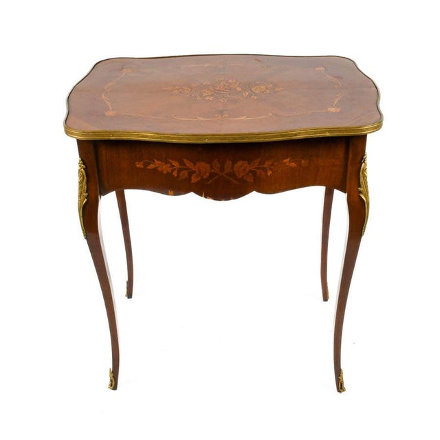 Graceful and richly detailed, this antique French-style side table captures the refinement and decorative artistry...