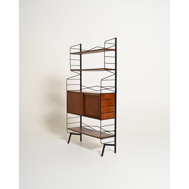 Teak frame with three adjustable shelves, four drawers, and a storage compartment with a sliding door. Scandinavian...