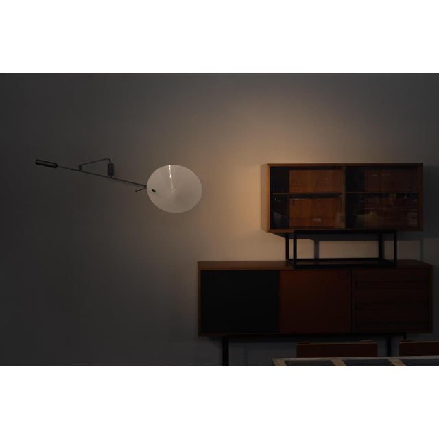 Very nice adjustable wall lamp model 242p designed by Robert Mathieu, France 1957. The dark grey painted metal structure...