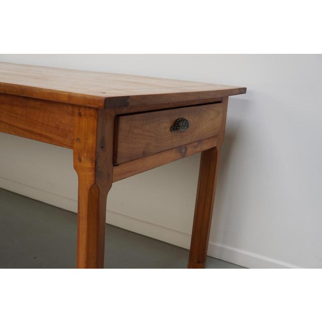 This antique French table was made from cherry in the late 19th century. It is in a very nice antique condition with...