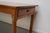 This antique French table was made from cherry in the late 19th century. It is in a very nice antique condition with...