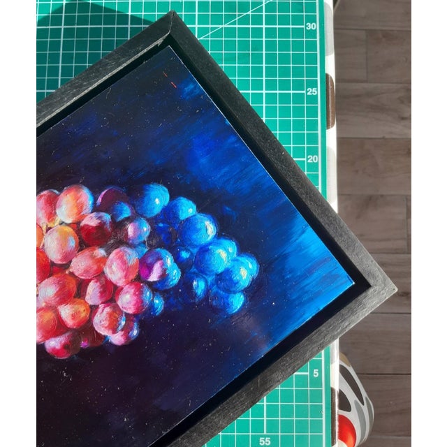 This oil painting on birch panel depicts a cluster of grapes, rendered in rich hues of purple and blue against a dark...