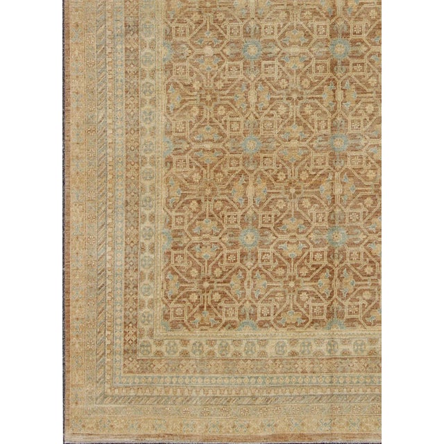 This Khotan features a geometric all-over design flanked by a repeating pattern in the border. The entirety of the piece...