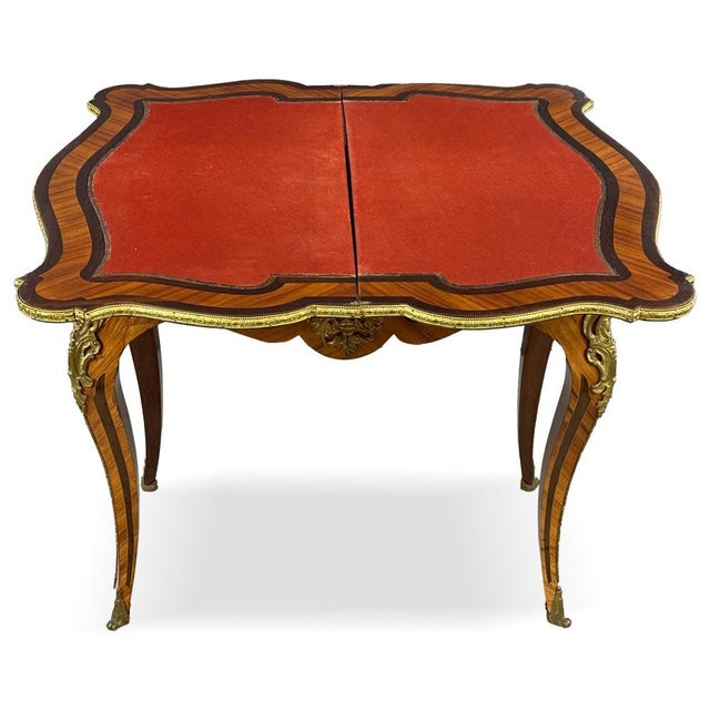 An elegant French Napoleon III game table, distinguished by its rich decorative character and refined craftsmanship. The...