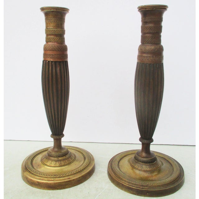 French Empire Bronze Candlesticks, c. 1830. Classic bronze single-stem candlesticks. Turned and tooled in fine detail to...