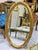 French Oval Wall Mirror With Floral Center Detail & Gold Leaf Frame For Sale - Image 3 of 5