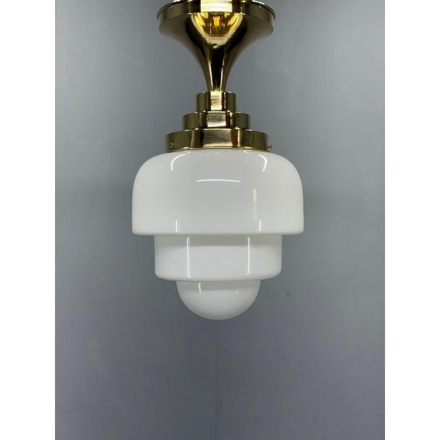 Authentic 1930s art deco flush mount from czechoslovakia featuring polished brass construction and a beautifully layered...