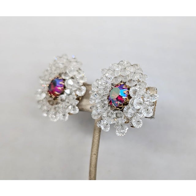 1960s goldtone prong set red/pink/blue aurora borealis center rhinestone with clear beaded surround clip earrings. Marked...