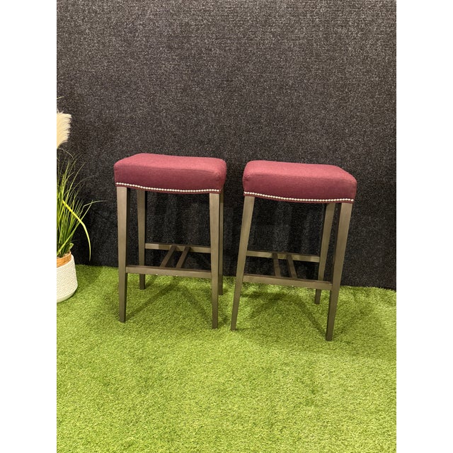 Elevate your kitchen island or home bar with this exceptional pair of authentic Ethan Allen backless bar stools....