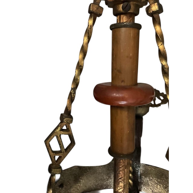 Striking early 20th century chandelier, landing Arts And Crafts warmth with emerging art deco geometry. This circa 1920s...