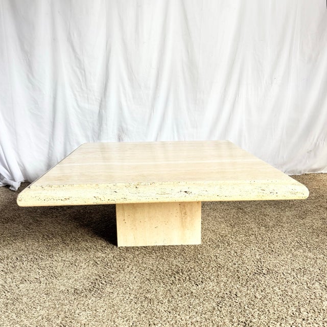 This vintage Italian travertine square top coffee table is a timeless study in material, proportion, and restraint....