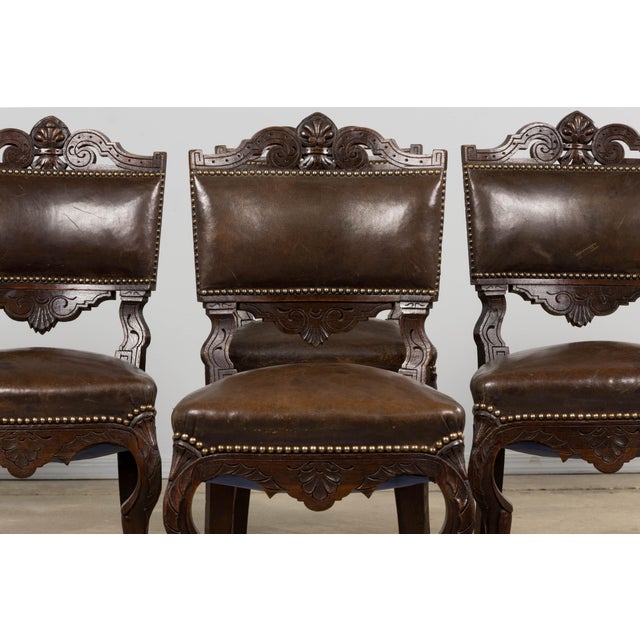 Set of eight French Louis XV dining chairs dating to the 19th century, sourced from Provence. Crafted from solid oak, the...