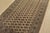 A tribal Bokhara rug hand-knotted with fine wool on a cotton foundation. This rug features rows of repeating medallions...