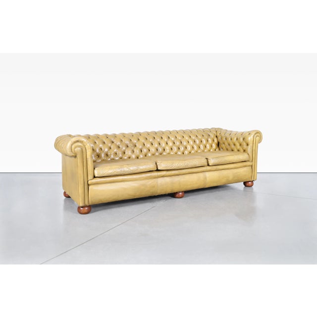 An enduring icon of British furniture design, this vintage English Chesterfield sofa captures the timeless appeal that has...
