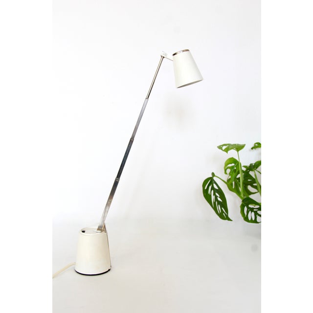 An iconic example of functional mid-century design, this vintage Lampette lamp was created in 1963 by Koch Creations....