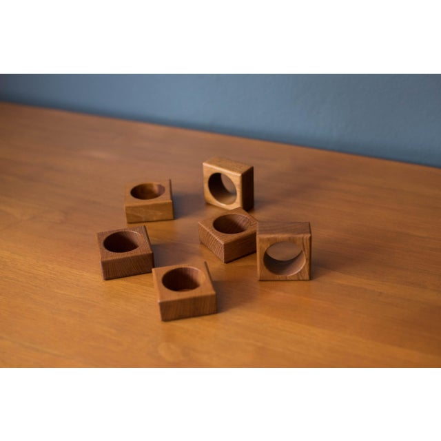 Vintage set of six square modernist napkin ring holders, circa 1960's. Features solid teak construction showcasing warm...