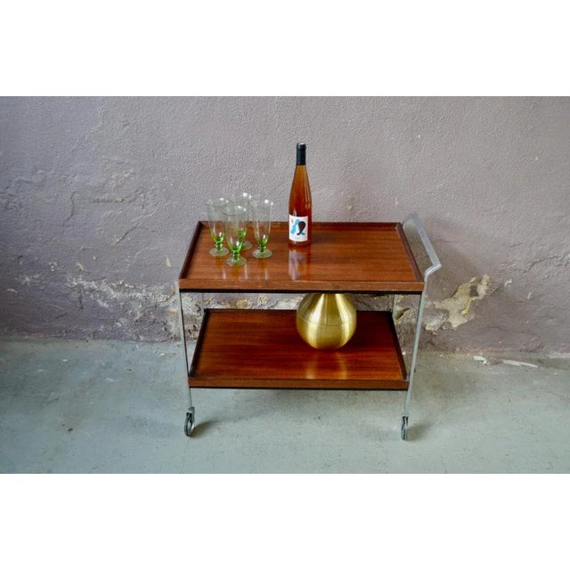 Signed Opal Möbel, this sideboard has a design in line with the Scandinavian modernist trend. The cart is made of two...