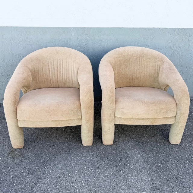 Striking pair of vintage Postmodern lounge chairs featuring dramatic sculptural silhouettes and soft tan velvet...
