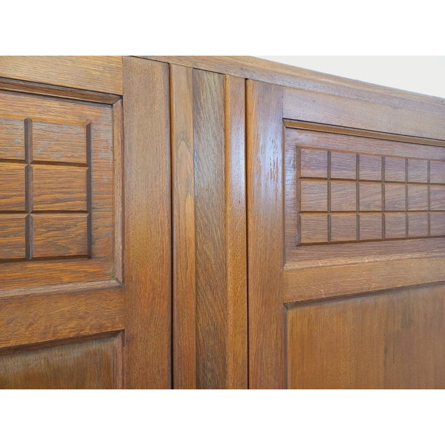 Vintage 1950s wardrobe, beautiful Art Deco style, made of solid oak, with ample storage: two doors carved with raised...